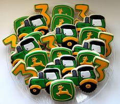 decorated cookies in the shape of tractors on a plate