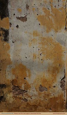 an old wall that has been painted yellow and brown with some paint chipping off it