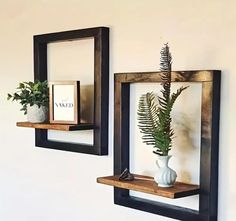 there are two wooden shelves with plants on them and one is holding a card box