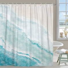 a bathroom with a shower curtain that has blue and white watercolor paint on it