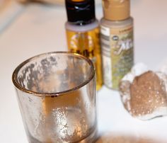 a shot glass sitting on top of a table next to bottles and other items in the background