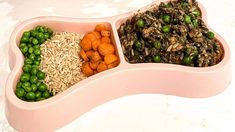 two bowls filled with rice, peas and carrots next to each other on a table