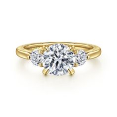 three stone engagement ring in yellow gold with diamonds on the sides and an oval diamond center