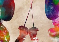 two boxing gloves hanging from strings in front of an old paper background with watercolor stains