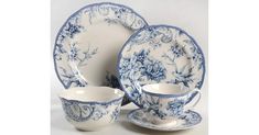 a blue and white dinner set with matching saucers