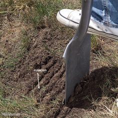 someone is digging dirt in the ground with a garden shovel on top of their foot