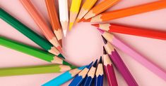 many colored pencils are arranged in a circle