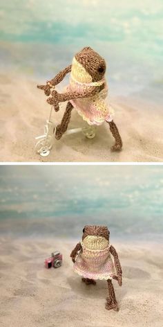 there is a toy frog on the beach with a hat and umbrella in it's hands