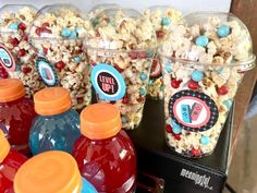 several plastic containers filled with candy and popcorn