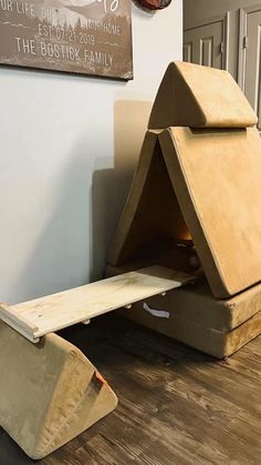 a cat house made out of cardboard sitting on the floor