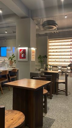 an empty restaurant with wooden tables and chairs