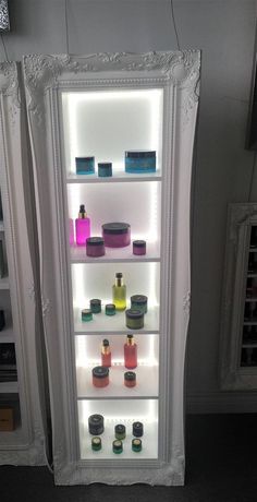 an illuminated display case in a store filled with beauty products