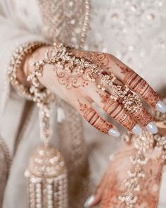 a close up of a person's hand with hennap and jewelry on it