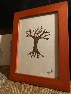 a framed picture with a tree drawn on it