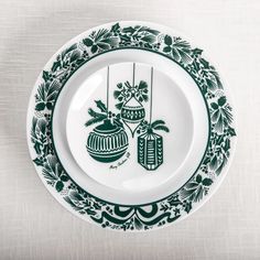 a green and white plate with christmas decorations on it