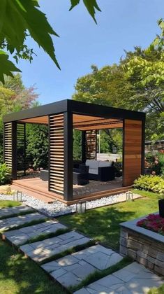 an outdoor living area in the middle of a garden