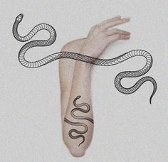 a woman's arm with a tattoo on it and a snake wrapped around the arm