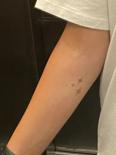 a person with a star tattoo on their arm