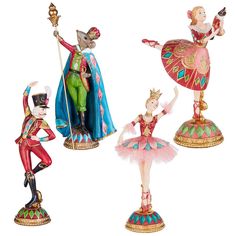 three figurines of people dressed in costumes