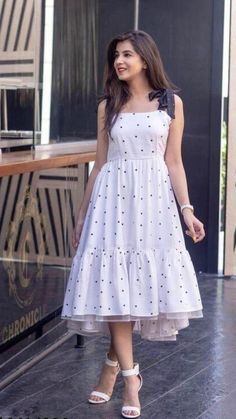 Polka Print Fit & Flared White Dress   • Fabric: Crepe  • Sleeve Length: Sleeveless  • Pattern: Printed  • Net Quantity (N): 1  • Sizes:  • S (Bust Size: 34 in)   • M (Bust Size: 36 in)   • L (Bust Size: 38 in)   • XL (Bust Size: 40 in)   XXL (Bust Size: 42 in)   Price: 500 Western Dress Poses For Women, Cute Long Frocks, Simple White Frock Design, Poses In Long Dresses, Cute Frocks For Women, White Frocks For Women, Long Dress Poses, Polka Dot Long Dress, Shaurya Sanadhya