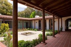 an outdoor courtyard with brick pavers and potted plants