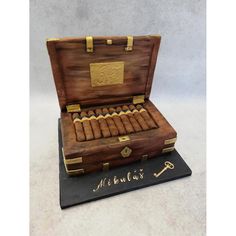 a cake made to look like an old trunk with cigars in it and the words,