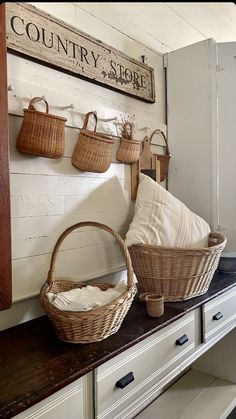 baskets and pillows are sitting on the counter