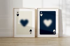 two framed cards with hearts on them sitting next to each other in front of a white wall