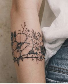 a woman's arm with flowers on it