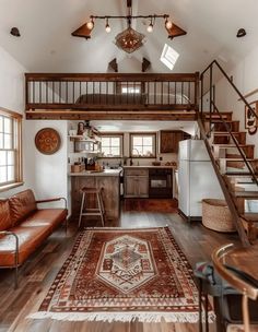 a living room filled with furniture and a stair case