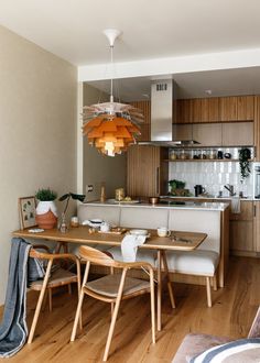 a kitchen and dining room with wood flooring