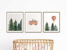 three paintings on the wall above a crib with a baby's bed in it