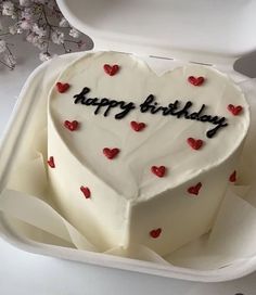 a heart shaped birthday cake in a white box