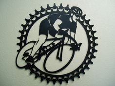 a metal clock with a bicycle on it's face and an image of a man riding a bike