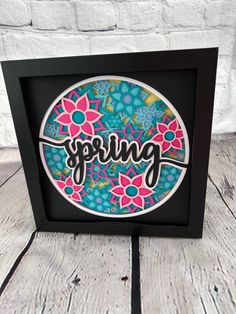 an image of a paper art with the word spring written in black and pink on it