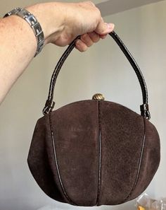 This is a beautiful, timeless vintage brown suede bag.  Balloon shape, very nice soft suede.  Patterned leather design as well as frame and handle.  The claps is gold metal.  The inside is lined with brown fabric.  There are two pockets.  It includes a mirror labeled Bergdorf Goodman as well as a little coin purse.  The lining is in excellent condition.  There is faint Cobletz mark.  This is very beautiful bag in great condition.   Measurements Height - 12" Width - 10 1/2" Happy to answer any questions or provide additional pics Please note that my store doesn't accept returns and doesn't ship internationally Luxury Brown Bags With Turn-lock Closure, Luxury Brown Bag With Suede Lining, Luxury Vintage Brown Hobo Bag, Luxury Antique Brown Bag, Luxury Antique Brown Bags, Luxury Handmade Brown Evening Bag, Classic Luxury Brown Evening Bag, Luxury Brown Classic Evening Bag, Luxury Classic Brown Evening Bag