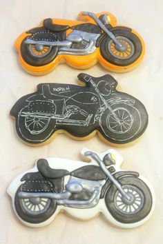 three decorated cookies with motorcycles on them