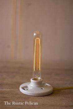 a light bulb sitting on top of a wooden table