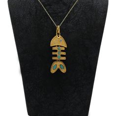 Our uniquely designed necklace features a stunning fish figure, crafted from high-quality brass material and finished with a pure 24-carat gold plating. The fish is adorned with natural turquoise stones and a zircon stone for the eye, adding an elegant touch to the piece. The necklace measures 18.11 inches in length, while the pendant has a height of 2.95 inches and a width of 1.18 inches, making it a statement piece that will catch the eye and elevate any outfit. With its intricate detailing and premium materials, this necklace is the perfect addition to any jewelry collection, and a beautiful representation of the beauty of ocean life. -Marvels Fishbone Collection: Pendant, Necklace, Animal Bone Accessories -Sea Life Inspired: Marvels Jewelry, Fishbone Pendant, Necklace -Ocean Treasures: Fish Bone Bracelet, Ocean Accessories, Sea Life Necklace, Fish Skeleton Necklace, Animal Bone Jewelry, Fish Bone Necklace, Luxury Gold Fish-shaped Necklace, Marvel Jewelry, Skeleton Necklace