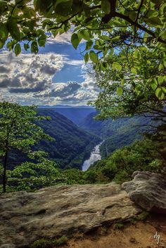 a view from the top of a mountain looking down on a valley and river below