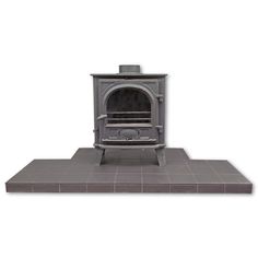 an old fashioned stove sitting on top of a tile floor