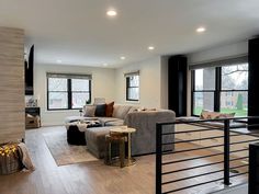 a living room filled with furniture and windows