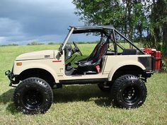 an off - road vehicle parked in the middle of a field