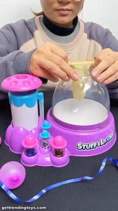 a girl is playing with some toys on the table