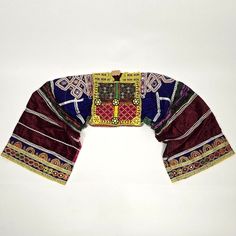 This vintage Afghan choli crop top features traditional characteristics, including a short body and very long sleeves with heavily decorated cuffs. The sleeves, usually worn as puff sleeves, are adorned with embroidered golden Oriental patterns and patches of miniature beads, set upon a velvety fabric. The top can be worn as a statement piece or repurposed for your sewing & fashion project. It also makes a stunning decoration for the wall, hung on driftwood or a beautiful branch, or displayed on Fitted Multicolor Traditional Wear For Festival, Traditional Tops With Traditional Patterns For Festivals, Traditional Tops With Festive Patterns, Unstitched Choli Blouse For Festive Rituals, Ceremonial Choli With Multicolor Embroidery And Traditional Drape, Bohemian Tops With Traditional Drape For Festive Occasions, Traditional Multicolor Choli For Festivals, Traditional Ceremonial Tops For Festivals, Fitted Folk Traditional Wear For Festive Season