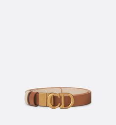 The Saddle belt has become a Dior icon and a wardrobe classic. It is offered in a reversible variation, thanks to its swivel feature. Crafted in golden saddle smooth calfskin on one side and caramel beige on the other, it is embellished with the antique gold-finish metal CD buckle. The design also features two removable loops that can be worn in a tonal or contrasting fashion. The timeless accessory elegantly highlights the waist and will coordinate well with jeans, a skirt or a dress.. 85 Christian Dior Paris, Dior Star, Icon Shoes, Dior Book Tote, Wardrobe Classic, Christian Dior Couture, Star Shoes, Silver Cufflinks, Fashion Jewelry Earrings