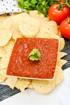 a bowl of salsa with tortilla chips and tomatoes in the background text reads copycat chili's salsa