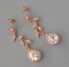 Cubic Zirconia earrings are available with rose gold plated, rhodium plated and yellow gold plated finish. Please select the finish for earrings before checkout. Earrings are about 1 3/4 inches (4.3cm) long. Materials and sizes: Drops: 16mm high and 11mm wide Leaves: 23mm long and 12mm wide Rounds: 6mm Zircon color is clear 1) Rose gold plated over brass teardrops, leaves and rounds Silver ear studs posts 2) Rhodium plated over brass drops, rounds and leaves Studs earrings posts are silver 3) Ye Silver Rose Design Earrings For Wedding, Elegant Rose Design Earrings For Wedding, Elegant Rose Design Wedding Earrings, Dangle Earrings With Rose Design For Wedding, Rose Gold Rose Design Earrings For Party, Gold Rose Design Earrings For Wedding, Rose Gold Pierced Bridal Earrings For Wedding, Rose Gold Rose Design Wedding Earrings, 1 Rose