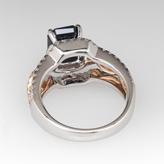 This gorgeous 18K white and rose gold ring is centered with one (1) emerald cut natural sapphire weighing 2.71 carats that is set into a four-prong setting. The top half of the ring is accented with one hundred two (102), prong set, round brilliant cut diamonds. The ring measures 12.0mm at the top, rises 9.5mm above the finger, tapering to 3.1mm wide and 1.3mm thick at the base of the shank. It is currently a size 5.75. Luxury Emerald Cut Sapphire Ring With Diamond Detail, Luxury Square Cut Sapphire Ring With Prong Setting, Gia Certified Square Cut Sapphire Ring, Elegant Gia Certified Square Cut Sapphire Ring, Elegant Gia Certified Emerald Cut Sapphire Ring, Luxury Sapphire Ring With Emerald Cut And Accent Stones, Emerald-cut Sapphire Ring In Rose Gold With Accent Stones, Emerald-cut Rose Gold Sapphire Ring With Accent Stones, Rose Gold Emerald-cut Sapphire Ring With Accent Stones