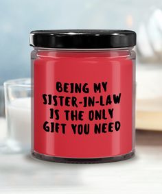 a red glass jar that says being my sister - in - law is the only gift you need